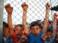 Syrian refugee children behind a fence at the Nizip refugee camp in Gaziantep province, southeastern Turkey Saturday, April 23, 2016.