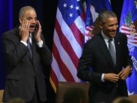 US President Barack Obama (R) and U.S. Attorney General Eric Holder react at the introduction of singer Aretha Franklin who sung during a farwell ceremony at the Justice Department February 27, 2015.