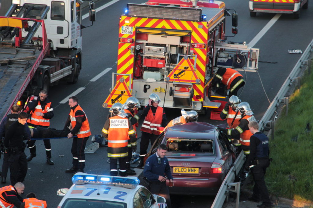 Rescue workers evacuate an injured person as police inspect the site of an accident on the A16 motorway in Coudekerque, near Dunkerque, northern France, on May 5, 2016. One person died and several were injured on early May 5 in three accidents which occurred on the A16 motorway near the French-Belgian border, including one involving a vehicle being persued by Belgian police. / AFP / LA VOIX DU NORD / Alexis Constant (Photo credit should read ALEXIS CONSTANT/AFP/Getty Images)