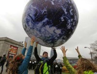 Environmental activists play with a giant globe on the streets in a rally demanding more action to battle climate change during the 19th conference of the United Nations Framework Convention on Climate Change (COP19) in Warsaw November 16, 2013. REUTERS/KACPER PEMPEL