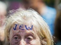 A woman with the word 'JEW' inked on her forehead attends an anti-fascist demonstration on Whitehall in central London on July 4, 2015, countering an anti-Jewish rally held by a group of far-right protesters.