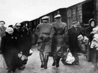 circa 1941: Nazi officers supervise Jews leaving railway trucks during the deportation to the camps. (Photo by Hulton Archive/Getty Images)