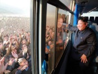 DEMOCRATIC PEOPLE'S REPUBLIC OF KOREA, Rason : This picture released from North Korea's official Korean Central News Agency (KCNA) on October 8, 2015 shows North Korean leader Kim Jong-Un (R) waving to a crowd from a bus while inspecting a newly-built village at Paekhak-dong in Sonbong District of flood-hit Rason City. AFP PHOTO / KCNA via KNS REPUBLIC OF KOREA OUT THIS PICTURE WAS MADE AVAILABLE BY A THIRD PARTY. AFP CAN NOT INDEPENDENTLY VERIFY THE AUTHENTICITY, LOCATION, DATE AND CONTENT OF THIS IMAGE. THIS PHOTO IS DISTRIBUTED EXACTLY AS RECEIVED BY AFP. ---EDITORS NOTE--- RESTRICTED TO EDITORIAL USE - MANDATORY CREDIT "AFP PHOTO / KCNA VIA KNS" - NO MARKETING NO ADVERTISING CAMPAIGNS - DISTRIBUTED AS A SERVICE TO CLIENTS