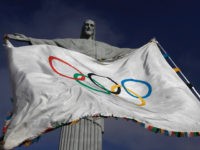 The Olympic Flag flies in front of ''Christ the Redeemer'' statue during a blessing ceremony in Rio de Janeiro August 19, 2012. REUTERS/RICARDO MORAES