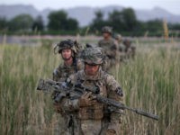 U.S. soldiers from 5-20 infantry Regiment attached to 82nd Airborne walk while on patrol in Zharay district in Kandahar province, southern Afghanistan April 24, 2012. REUTERS/BAZ RATNER