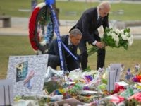 President Barack Obama and Vice President Joe Biden place flowers down during their visit to a memorial to the victims of the Pulse nightclub shooting, Thursday, June 16, 2016 in Orlando, Fla.