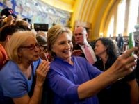 Democratic presidential candidate Hillary Clinton takes a photo with a member of the audience following a rally at the Cincinnati Museum Center at Union Terminal in Cincinnati, Monday, June 27, 2016. (AP Photo/Andrew Harnik)