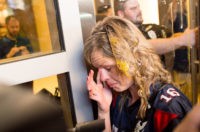 A woman wipes egg off her face after being pursued by protesters while leaving Republican presidential candidate Donald Trump's campaign rally on Thursday, June 2, 2016, in San Jose, Calif. A group of protesters attacked Trump supporters who were leaving the presidential candidate's rally in San Jose on Thursday night. A dozen or more people were punched, at least one person was pelted with an egg and Trump hats grabbed from supporters were set on fire on the ground.  (AP Photo/Noah Berger)
