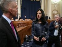Huma Abedin (C), former deputy chief of staff for former Secretary of State Hillary Clinton, talks with House Select Committee Chairman Trey Gowdy (R-SC) during a break in Clinton's testimony October 22, 2015 on Capitol Hill in Washington, DC. The committee held a hearing to continue its investigation on the attack that killed Ambassador Chris Stevens and three other Americans at theÊdiplomatic compound in Benghazi, Libya,Êon the evening of September 11, 2012. (Photo by