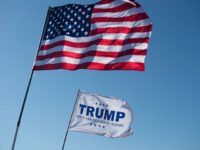 An American Flag and a Donald Trump flag wave outside a Donald Trump rally at Millington Regional Jetport on February 27, 2016 in Millington, Tennessee. / AFP / Michael B. Thomas        (Photo credit should read MICHAEL B. THOMAS/AFP/Getty Images)
