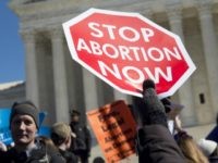 Anti-abortion activists rally outside of the Supreme Court in Washington, DC, March 2, 2016, following oral arguments in the case of Whole Woman's Health v. Hellerstedt, which deals with access to abortion in Texas. The US Supreme Court on March 2 took up its most important abortion case in a generation, the outcome of which could impact the ability of millions of women to end an unwanted pregnancy -- as well as the White House race. With the court now split evenly between liberals and conservatives following the death of Antonin Scalia, all eyes are on Justice Anthony Kennedy, who wields a swing vote on the issue, one of the most divisive in the world of US politics. / AFP / SAUL LOEB (Photo credit should read )