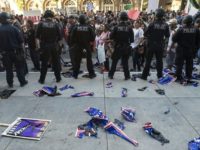 Torn Trump signs are seen on the ground behind a police skirmish line during a protest near where Republican presidential candidate Donald Trump held a rally in San Jose, California on June 02, 2016. 
Protesters attacked Trump supporters as they left the rally, burned an american flag, trump paraphernalia and scuffled with police and each other. / AFP / JOSH EDELSON        (Photo credit should read JOSH EDELSON/AFP/Getty Images)