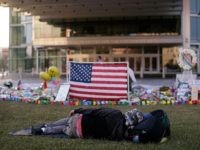 ORLANDO, FL - JUNE 15:  A man sleeps in the early morning hours at a makeshift memorial for the victims of the Pulse Nightclub shooting at the Dr. Phillips Center for Performing Arts on June 15, 2016 in Orlando, Florida. The shooting at Pulse Nightclub, which killed 49 people and injured 53, is the worst mass-shooting event in American history. (Photo by Drew Angerer/Getty Images)