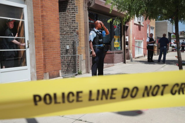CHICAGO, IL - JUNE 15: Police investigate a crime scene after two people were shot on the near Westside on June 15, 2016 in Chicago, Illinois. One witness said two area businessmen were arguing over the price of a service when one of the men pulled a gun and shot the other and his son after being assaulted with a baton. One-thousand-six-hundred-eighty-nine people have been shot in Chicago since January 1. (Photo by Scott Olson/Getty Images)