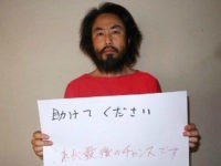 CORRECTION - This undated picture provided by Japan's Jiji Press news agency, taken at an undisclosed location, on May 30, 2016 shows Japanese freelance journalist Jumpei Yasuda holding a piece of paper with a handwritten message in Japanese. The fresh photo, which received widespread coverage in Japanese media on May 30, 2016, shows Yasuda, who has been missing for almost a year, wearing an orange shirt, his hair and beard grown long. / AFP / JIJI PRESS / JIJI PRESS / Japan OUT / The erroneous mention[s] appearing in the metadata of this photo by JIJI PRESS has been modified in AFP systems in the following manner: corrects first name spelling [Jumpei] instead of [Junpei]. Please immediately remove the erroneous mention[s] from all your online services and delete it (them) from your servers. If you have been authorized by AFP to distribute it (them) to third parties, please ensure that the same actions are carried out by them. Failure to promptly comply with these instructions will entail liability on your part for any continued or post notification usage. Therefore we thank you very much for all your attention and prompt action. We are sorry for the inconvenience this notification may cause and remain at your disposal for any further information you may require. (Photo credit should read JIJI PRESS/AFP/Getty Images)