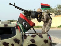 A Member of a brigade loyal to the Fajr Libya (Libya Dawn), an alliance of Islamist-backed fighters, stands on a pick up truck mounted with a machine gun during a military parade following battles against the Islamic State (IS) group, in the city of Sabratha, west of the capital Tripoli, on February 28, 2016. On February 19, a US air strike near Sabratha targeted a suspected IS training camp, killing 50 people. / AFP / MAHMUD TURKIA (Photo credit should read MAHMUD TURKIA/AFP/Getty Images)
