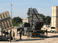 Israeli soldiers walk near an Israeli Irone Dome defence system (L), a surface-to-air missile (SAM) system, the MIM-104 Patriot (C), and an anti-ballistic missile the Arrow 3 (R) during Juniper Cobra's joint exercise press briefing at Hatzor Israeli Air Force Base in central Israel, on February 25, 2016.