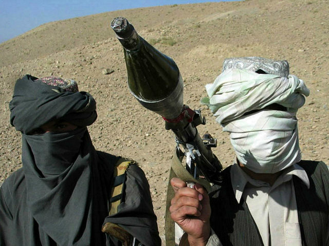 Face-covered militants who they say are Talibans pose with an RPG in Zabul province, southern of Kabul, Afghanistan Saturday, Oct. 7, 2006. A Taliban commander said in a sit-down interview that insurgent fighters will battle "Christian" troops until they leave Afghanistan and a fundamentalist government is established in Kabul, warning that hundreds of militants are ready to launch suicide attacks to again install strict Islamic law. The regional-level commander, Mullah Nazir Ahmed Hamza, said the Taliban still has thousands of fighters despite heavy losses in recent battles, that support for the hardline movement is increasing every day and that U.S. and NATO forces would have a tough time beating the fighters without air support. (AP Photo/Allauddin Khan)