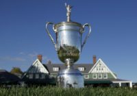 The US Open Championship Trophy is displayed in front of the clubhouse at Oakmont Country Club in Pennsylvania