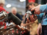 An attendee handles a revolver in the Sturm, Ruger & Co., Inc. booth on the exhibition floor of the 144th National Rifle Association (NRA) Annual Meetings and Exhibits at the Music City Center in Nashville, Tennessee, U.S., on Saturday, April 11, 2015. Top Republican contenders for their party's 2016 presidential nomination are lining up to speak at the annual NRA event, except New Jersey Governor Chris Christie and Kentucky Senator Rand Paul, who were snubbed by the country's largest and most powerful gun lobby. Photographer: Daniel Acker/Bloomberg via Getty Images
