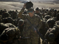 An Afghan Army soldier adjusts his helmet during an exercise at a training facility in the outskirts of Kabul, Afghanistan, Tuesday, Nov. 26, 2013. The Afghan National Security Forces depend exclusively on billions of dollars in funding from the United States and its allies, money that is now at risk following President Hamid Karzai’s decision to defer signing a security agreement until after the April elections. The US wants the deal signed by the end of the year so that it can plan for a residual force after 2014, when all foreign combat forces leave. If the deal is not signed, billions in funding for the army and police may dry up. (AP Photo/Anja Niedringhaus)