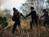 Immigrants walk handcuffed after illegally crossing the U.S.-Mexico border and being caught by the U.S. Border Patrol on December 7, 2015 near Rio Grande City, Texas. Border Patrol agents continue to capture hundreds of thousands of undocumented immigrants, even as the total numbers of those crossing has gone down. (Photo by