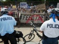 People protest through a security fence outside of the Wells Fargo Center, venue of the 2016 Democratic National Convention, during march holding signs in support of former Democratic presidential candidate Bernie Sanders during a protest outside the DNC, July 25, 2016 in Philadelphia, Pennsylvania. / AFP / Patrick T. Fallon (Photo credit should read