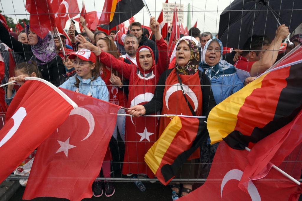 Supporters of Turkish President Recep Tayyip Erdogan attend a rally with German and Turkish flags on July 31, 2016 in Cologne, as tensions over Turkey's failed coup put authorities on edge. Police said some 20,000 people had joined in the demonstration staged by groups including the pro-Erdogan Union of European-Turkish Democrats (UETD). / AFP / dpa / Henning Kaiser / Germany OUT (Photo credit should read HENNING KAISER/AFP/Getty Images)