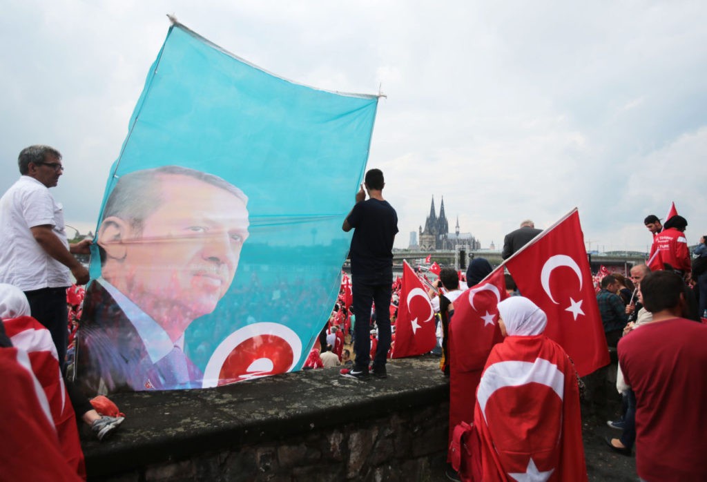 Supporters of Turkish President Recep Tayyip Erdogan attend a rally on July 31, 2016 in Cologne, as tensions over Turkey's failed coup put authorities on edge. Police said some 20,000 people had joined in the demonstration staged by groups including the pro-Erdogan Union of European-Turkish Democrats (UETD). / AFP / DPA / Oliver Berg / Germany OUT (Photo credit should read OLIVER BERG/AFP/Getty Images)