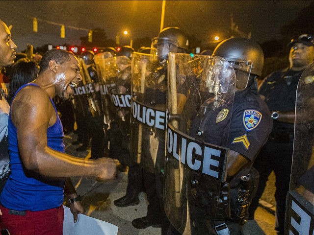 BATON ROUGE, LA -JULY 08: Protesters face off with Baton Rouge police in riot gear across the street from the police department on July 8, 2016 in Baton Rouge, Louisiana. Alton Sterling was shot by a police officer in front of the Triple S Food Mart in Baton Rouge on July 5th, leading the Department of Justice to open a civil rights investigation. (Photo by Mark Wallheiser/Getty Images)