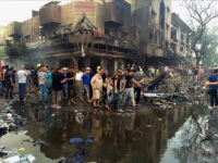 In this Sunday, July 3, 2016 photo, civilians carry the body of a victim killed in a massive suicide truck bomb attack in Karada, Iraq. Iraq’s deadliest single bombing in 13 years of war has turned the Baghdad district where it took place into the centerpiece in an increasingly bitter rivalry between the country’s prime minister and Iranian-backed Shiite militias eager to hold sway over the city’s most diverse and prosperous area. (AP Photo/Khalid Mohammed)