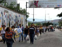 Venezuelans carrying groceries cross the Simon Bolivar bridge from Cucuta in Colombia back to San Antonio de Tachira in Venezuela, on July 10, 2016. Thousands of Venezuelans crossed Sunday the border with Colombia to take advantage of its 12-hour opening after it was closed by the Venezuelan government 11 months ago. Venezuelans rushed to Cucuta to buy food and medicines which are scarce in their country. / AFP / GEORGE CASTELLANOS (Photo credit should read GEORGE CASTELLANOS/AFP/Getty Images)