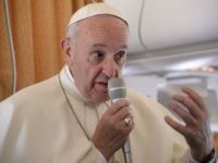 Pope Francis speaks onboard a plane on his way to Krakow, Poland, on July 27, 2016. Pope Francis heads to Poland for an international Catholic youth festival with a mission to encourage openness to migrants. / AFP / POOL / FILIPPO MONTEFORTE (Photo credit should read FILIPPO MONTEFORTE/AFP/Getty Images)