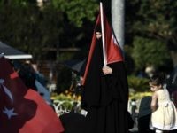 A veiled woman holds a Turkish flag during a demonstration in Istanbul in support the government on July 16, 2016, following a failed coup attempt. Turkish authorities said they had regained control of the country on July 16 after thwarting a coup attempt by discontented soldiers to seize power from President Recep Tayyip Erdogan that claimed more than 250 lives. / AFP / ARIS MESSINIS (Photo credit should read ARIS MESSINIS/AFP/Getty Images)