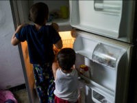 Young childern look in an empty refrigerator at a home in the Catia neighborhood on the outskirts of Caracas, Venezuela, on Thursday, June 30, 2016. In an attempt to regain control, President Nicolas Maduro has tapped loyal neighborhood groups, called Local Committees for Supply and Production (CLAPs), and put them in charge of distributing as much as 70 percent of the nation's food. Photographer: Manaure Quintero/Bloomberg via Getty Images