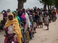 Women and children wait on June 30, 2016, to visit one of the UNICEF nutrition clinics, on the outskirts of Maiduguri, capital of Borno State, an area that has been torn apart for the last seven years by Boko Haram insurgents