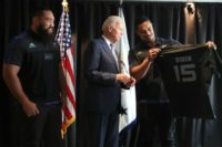 US Vice President Joe Biden receives a personalised All Black rugby jersey from players Jerome Kaino (R) and Charlie Faumuina
