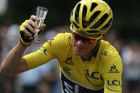 Great Britain's Chris Froome is enjoys a glass of champagne as he rides during final stage of the Tour de France on July 24, 2016