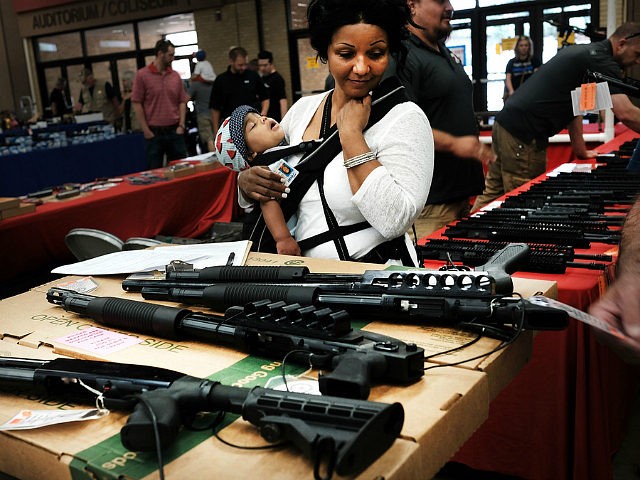 FORT WORTH, TX - JULY 10: A woman admires weapons at a gun show where thousands of different weapons are displayed for sale on July 10, 2016 in Fort Worth, Texas. The Dallas and Forth Worth areas are still mourning the deaths of five police officers last Thursday evening by a lone gunman. (Photo by Spencer Platt/Getty Images)