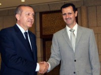 FILE - In this Monday, Oct. 11, 2010 file photo, Syrian President Bashar Assad, right, shakes hands with Turkish Prime Minister Recep Tayyip Erdogan, left, at al-Shaab presidential palace in Damascus, Syria. Within minutes of news breaking of a coup against Recep Tayyeb Erdogan, government-held areas in Syria broke out in celebratory gunfire that lasted throughout the night. In bars across the capital Damascus, revelers celebrated the news, drinking to the removal of Turkey's strongman they blame for fueling their country's five-year civil war. But Erdogan survived, and judging by the surprise reversal of rebel fortunes in Aleppo this week, so has his support for the rebels. (AP Photo/Bassem Tellawi, File)