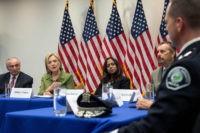 NEW YORK, NY - AUGUST 18: Flanked by Bill Bratton (L), commissioner of the New York City Police Department, and policy advisor Maya Harris (R) look on as Democratic presidential candidate Hillary Clinton delivers opening remarks during a meeting with law enforcement officials at the John Jay College of Criminal Justice, August 18, 2016 in New York City. The meeting included police chiefs from several metropolitan departments. (Photo by Drew Angerer/Getty Images