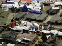 Evacuees take advantage of the shelter setup in the The Baton Rouge River Center arena as the area deals with the record flooding that took place causing thousands of people to seek temporary shelter on August 19, 2016 in Baton Rouge, Louisiana. Last week Louisiana was overwhelmed with flood water causing at least thirteen deaths and thousands of damaged homes. (Photo by