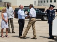 S President Barack Obama is greeted by Louisiana Governor John Bel Edwards and his wife Donna at Baton Rouge Metropolitan Airport in Baton Rouge, Louisiana, on August 23, 2016. Fresh from a two-week vacation, President Barack Obama visits flood-hit Louisiana, hoping to offer support to devastated communities and silence his critics. / AFP / NICHOLAS KAMM