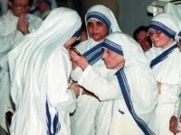 NEW YORK, UNITED STATES:  A nun who has just professed her vows to the the Missionaries of Charity kisses the cross as Mother Teresa presents it to her during a ceremony in a church in the Bronx, New York 11 June. Five nuns entered the Missionary and five more renewed their vows.  AFP PHOTO/HENNY RAY ABRAMS (Photo credit should read HENNY RAY ABRAMS/AFP/Getty Images)