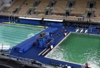 A picture taken on August 10, 2016 at the Maria Lenk Aquatics Stadium in Rio de Janeiro shows the Water Polo (L) pool and the diving pool of the Rio 2016 Olympic Games.  
Red-faced Rio Olympics organisers anxiously waited for the diving water to turn back from a nervy green to classic blue as a lack of chemicals was revealed as the cause of the colour changes. Heavy rain slowed the flow of new chemicals added to the water which was also green in the pool used for the synchronised swimming and water-polo.
 / AFP / CHRISTOPHE SIMON        (Photo credit should read CHRISTOPHE SIMON/AFP/Getty Images)