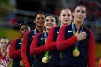 RIO DE JANEIRO, BRAZIL - AUGUST 09:  (L to R) Gold Medalists Simone Biles, Gabrielle Douglas, Lauren Hernandez, Madison Kocian and Alexandra Raisman of the United States stand on the podium for the national anthem at the medal ceremony for the Artistic Gymnastics Women's Team Final on Day 4 of the Rio 2016 Olympic Games at the Rio Olympic Arena on August 9, 2016 in Rio de Janeiro, Brazil.  (Photo by Laurence Griffiths/Getty Images)
