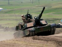 U.S. M1A2 Abrams tank moves to firing positions during joint military exercises at the Vaziani military base outside Tbilisi, Georgia, Wednesday, May 18, 2016. About 1,300 U.S., British and Georgian troops conducted joint exercises aimed at training the former Soviet republic's military for participation in the NATO Response Force. (AP Photo/Shakh Aivazov)