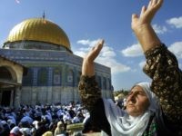 A Palestinian woman joins some 10,000 Palestinians in prayer at Jerusalem's Al-Aqsa mosque complex for their stricken leader Yasser Arafat, 05 November 2004, on the fourth Friday of the Muslim fasting month of Ramadan. Palestinian leader Yasser Arafat appeared close to death at a military clinic outside Paris today, as the Middle East prepared for the passing of one of the region's historic figures. AFP PHOTO/ATTA HUSSEIN (Photo credit should read ATTA HUSSEIN/AFP/Getty Images)