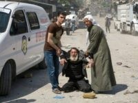 A man in a state of shock receives help on a street following a reported airstrike on April 23, 2016 in the rebel-held neighbourhood of Tareeq al-Bab in the northern city of Aleppo. The barrage of air strikes on Aleppo began around 10:00 local time and hit several neighbourhoods, including the heavily-populated Bustan al-Qasr district, an AFP correspondent in the city said. But the deadliest raid was on the Tareeq al-Bab neighbourhood on the eastern edges of the city. / AFP / KARAM AL-MASRI (Photo credit should read KARAM AL-MASRI/AFP/Getty Images)