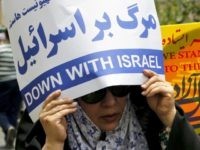 An Iranian woman holds an anti-Israeli slogan during a parade marking al-Quds (Jerusalem) Day in Tehran on July 01, 2016. Tens of thousands joined pro-Palestinian rallies in Tehran, as the annual Quds Day protests take on broader meaning for a region mired in bitter disputes and war. / AFP / ATTA KENARE (Photo credit should read ATTA KENARE/AFP/Getty Images)